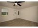 Bedroom with plank floors, ceiling fan and entry door at 1016 E Fillmore Ave, Orlando, FL 32809