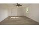 An unstaged bedroom featuring a ceiling fan, closet, window, and wood-look floors at 1016 E Fillmore Ave, Orlando, FL 32809