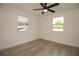 This cozy bedroom features wood-look floors and natural light from two windows at 1016 E Fillmore Ave, Orlando, FL 32809