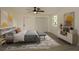This staged bedroom has a ceiling fan, closet, window, and modern decor at 1016 E Fillmore Ave, Orlando, FL 32809