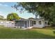 Charming home exterior featuring a screened porch and mature trees at 1016 E Fillmore Ave, Orlando, FL 32809