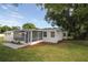Cozy home exterior featuring a screened porch and nicely landscaped yard at 1016 E Fillmore Ave, Orlando, FL 32809