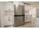 Bright kitchen featuring new stainless steel refrigerator and white cabinetry at 1016 E Fillmore Ave, Orlando, FL 32809