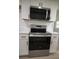 New stainless steel oven and microwave compliment the white cabinetry and quartz countertops at 1016 E Fillmore Ave, Orlando, FL 32809