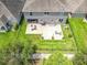 Aerial view of a backyard showcasing a stone patio with seating, lighting, and black metal fence at 1078 Vinsetta Cir, Winter Garden, FL 34787