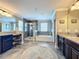 Bathroom featuring dual vanities, separate shower, and soaking tub with tiled flooring at 1078 Vinsetta Cir, Winter Garden, FL 34787