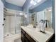 Bathroom featuring a glass shower and a vanity with a mirror and sink at 1078 Vinsetta Cir, Winter Garden, FL 34787