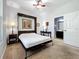 Neutral bedroom with murphy bed, ceiling fan, neutral carpet and a view to the ensuite bathroom at 1078 Vinsetta Cir, Winter Garden, FL 34787