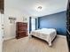 Bedroom featuring neutral carpet, bright blue accent wall, dresser, and comfortable furnishings at 1078 Vinsetta Cir, Winter Garden, FL 34787