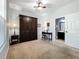 Bedroom with built-in murphy bed, ceiling fan, neutral carpet and view to ensuite bathroom at 1078 Vinsetta Cir, Winter Garden, FL 34787