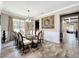 Elegant dining room with a glass top table, chandelier, and decorative painting at 1078 Vinsetta Cir, Winter Garden, FL 34787