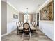 Formal dining room with large glass table and decorative painting on the wall at 1078 Vinsetta Cir, Winter Garden, FL 34787