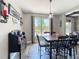 Dining room with wood table, modern lighting, and large window overlooking a spacious backyard at 1078 Vinsetta Cir, Winter Garden, FL 34787