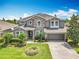 Beautiful two-story home showcasing well-maintained landscaping and a paved driveway leading to the garage at 1078 Vinsetta Cir, Winter Garden, FL 34787