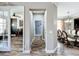 Hallway view into the dining room and office space, and features beautiful tile flooring at 1078 Vinsetta Cir, Winter Garden, FL 34787