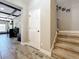 Hallway with stone-look floors leading to carpeted stairs, featuring an accent wall with Gathering photos at 1078 Vinsetta Cir, Winter Garden, FL 34787