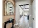 Hallway featuring a decorative mirror leading to the home's living areas at 1078 Vinsetta Cir, Winter Garden, FL 34787