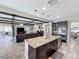 Open kitchen with a large center island, stainless appliances, and views of the living room at 1078 Vinsetta Cir, Winter Garden, FL 34787