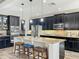 Gourmet kitchen featuring a granite-topped island with seating and stainless steel appliances at 1078 Vinsetta Cir, Winter Garden, FL 34787