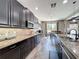 Spacious kitchen with black cabinets, granite countertops, mosaic backsplash, and stainless steel appliances at 1078 Vinsetta Cir, Winter Garden, FL 34787