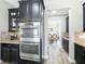 Kitchen cabinets with built in oven, mosaic backsplash, and views to the dining room at 1078 Vinsetta Cir, Winter Garden, FL 34787