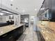 Modern kitchen with dark cabinets, stainless steel appliances, granite countertops, and open layout at 1078 Vinsetta Cir, Winter Garden, FL 34787
