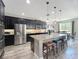 Spacious kitchen with stainless steel appliances, granite countertops, and a large island at 1078 Vinsetta Cir, Winter Garden, FL 34787