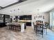 Modern kitchen featuring dark cabinets, granite countertops, stainless steel appliances, and an island with bar seating at 1078 Vinsetta Cir, Winter Garden, FL 34787