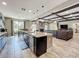 Kitchen island overlooking the living room, featuring stainless steel appliances and a fireplace at 1078 Vinsetta Cir, Winter Garden, FL 34787