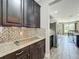 Granite countertops and mosaic backsplash in a kitchen with stainless steel refrigerator at 1078 Vinsetta Cir, Winter Garden, FL 34787