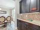Kitchen cabinets next to a dining room with a view to a large window at 1078 Vinsetta Cir, Winter Garden, FL 34787