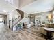 Bright living room featuring stylish furniture, a staircase with iron spindles, and a large decorative mirror at 1078 Vinsetta Cir, Winter Garden, FL 34787