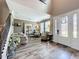 Inviting living room with high ceilings, elegant decor, and an ornate front door with leaded glass at 1078 Vinsetta Cir, Winter Garden, FL 34787