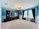 Spacious living room with blue walls and a large TV at 1078 Vinsetta Cir, Winter Garden, FL 34787