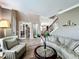 Open living room showcasing an ornate staircase, beautiful tile flooring, and views into other rooms at 1078 Vinsetta Cir, Winter Garden, FL 34787