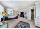Spacious main bedroom with plush carpet, decorative chandelier, and a seating area at 1078 Vinsetta Cir, Winter Garden, FL 34787