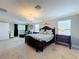 Bright main bedroom featuring a chandelier, plush carpet, and a comfortable chaise lounge at 1078 Vinsetta Cir, Winter Garden, FL 34787