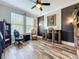 Cozy office space featuring hardwood floors, a ceiling fan, a bookcase, and a writing desk at 1078 Vinsetta Cir, Winter Garden, FL 34787