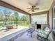 Inviting covered patio with outdoor kitchen, ceiling fan, and tranquil lake views at 1078 Vinsetta Cir, Winter Garden, FL 34787