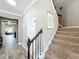 View of carpeted stairs with decorative metal railing and wood banister at 1078 Vinsetta Cir, Winter Garden, FL 34787