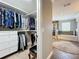 View of a walk-in closet leading to a bathroom with tiled floors and separate shower and tub at 1078 Vinsetta Cir, Winter Garden, FL 34787