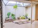 Enclosed courtyard with a variety of potted plants, rock ground cover, and natural light at 110 S Primrose Dr, Orlando, FL 32803