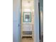 Charming bathroom vanity with a bright blue framed mirror and modern light fixture at 110 S Primrose Dr, Orlando, FL 32803