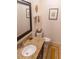 Bathroom vanity featuring a granite countertop, dark cabinetry, and decorative mirror at 110 S Primrose Dr, Orlando, FL 32803