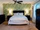 Stylish bedroom with a king bed, striking palm leaf wallpaper, and well-placed lighting at 110 S Primrose Dr, Orlando, FL 32803