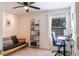 Bedroom features a futon, desk, bookshelf and ceiling fan at 110 S Primrose Dr, Orlando, FL 32803