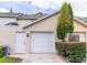 Charming townhome featuring a one car garage, welcoming front entrance, and lush, mature landscaping at 110 S Primrose Dr, Orlando, FL 32803