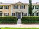 Charming townhouse with colorful facade, gray shutters, and manicured shrubbery at 110 S Primrose Dr, Orlando, FL 32803