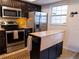 Kitchen with stainless appliances, center island, and dark cabinets at 110 S Primrose Dr, Orlando, FL 32803