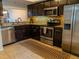 Updated kitchen features stainless steel appliances, tile backsplash and dark wood cabinetry at 110 S Primrose Dr, Orlando, FL 32803